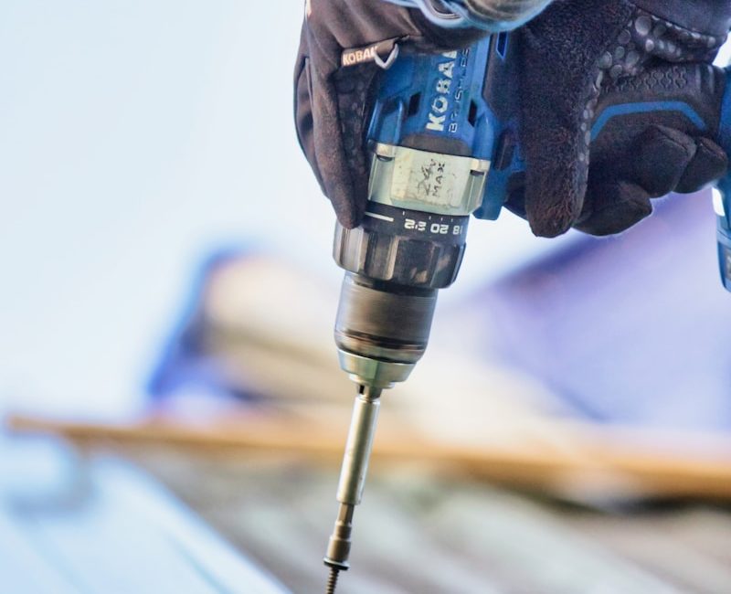 a person using a drill to drill a piece of wood