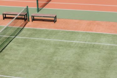 empty green and orange tennis fields