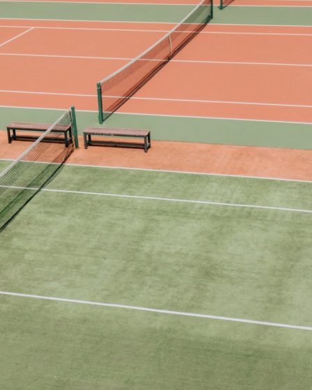 empty green and orange tennis fields