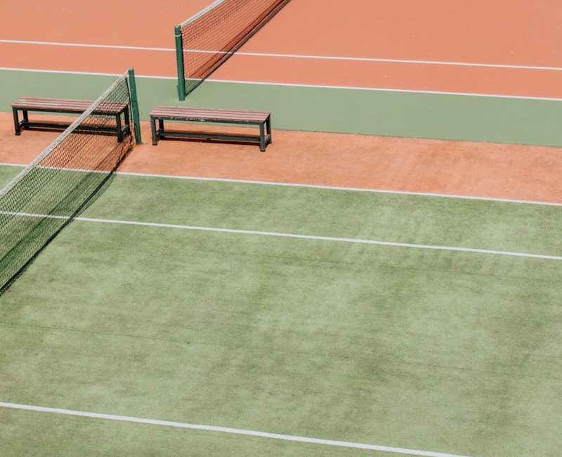 empty green and orange tennis fields